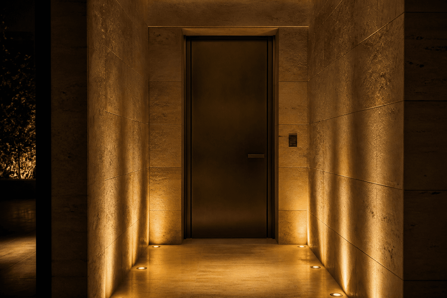 A closed dark-bronze door at the end of a limestone hall, a discreet keypad in the stone — protection as a room that does not open for everyone.